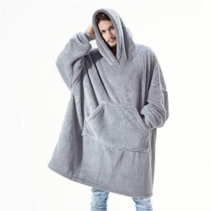 Person relaxing in an oversized blanket hoodie