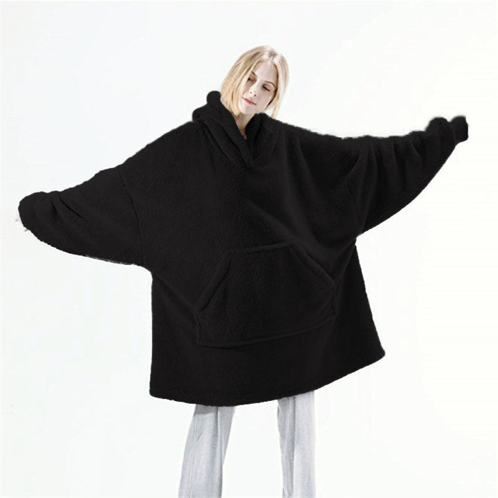 Person relaxing in an oversized blanket hoodie
