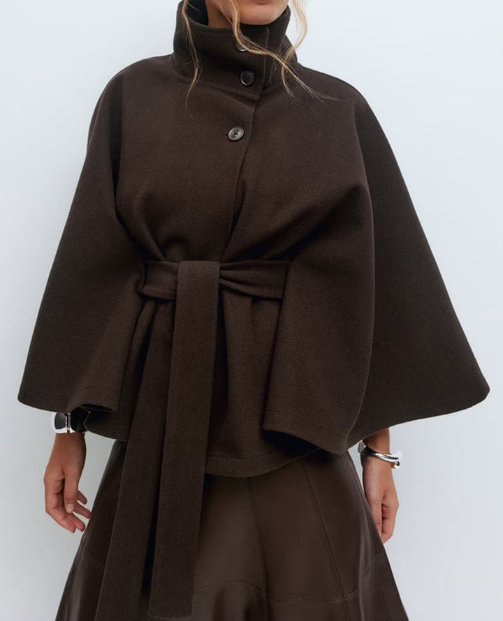Woman in belted short cape coat