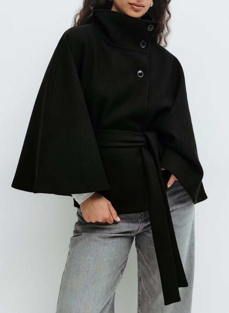 Woman in belted short cape coat