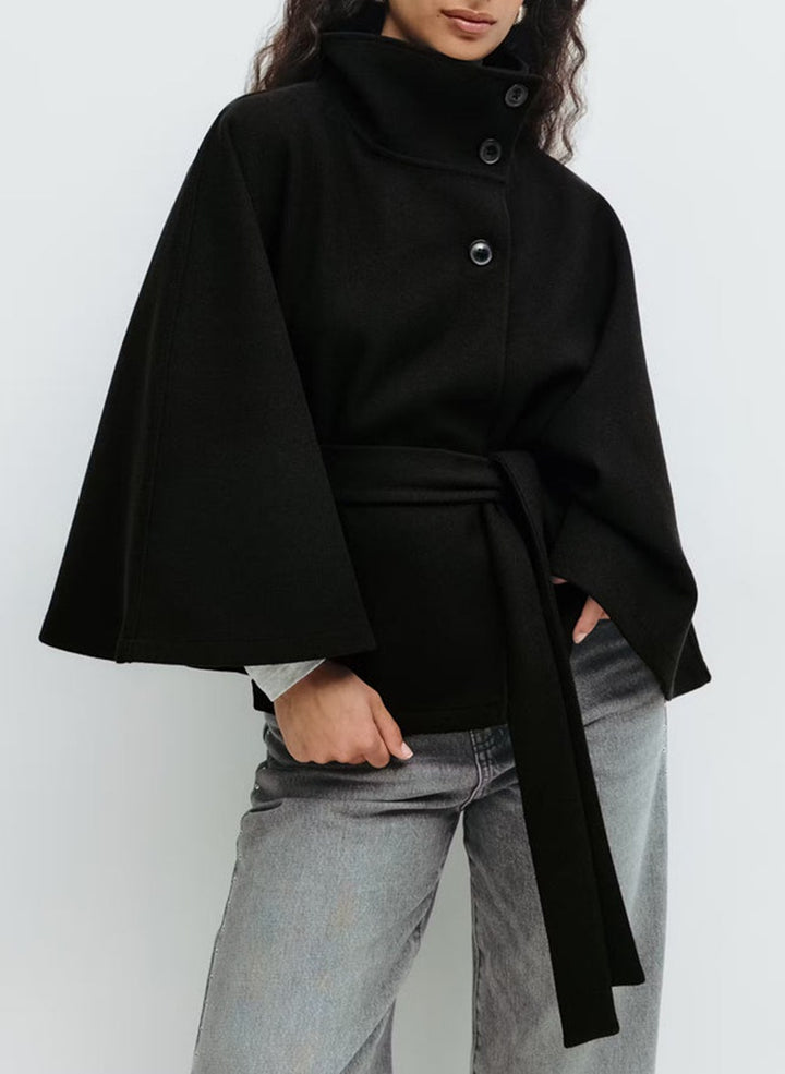 Woman in belted short cape coat