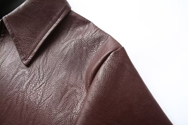 Woman in a cropped burgundy faux leather jacket