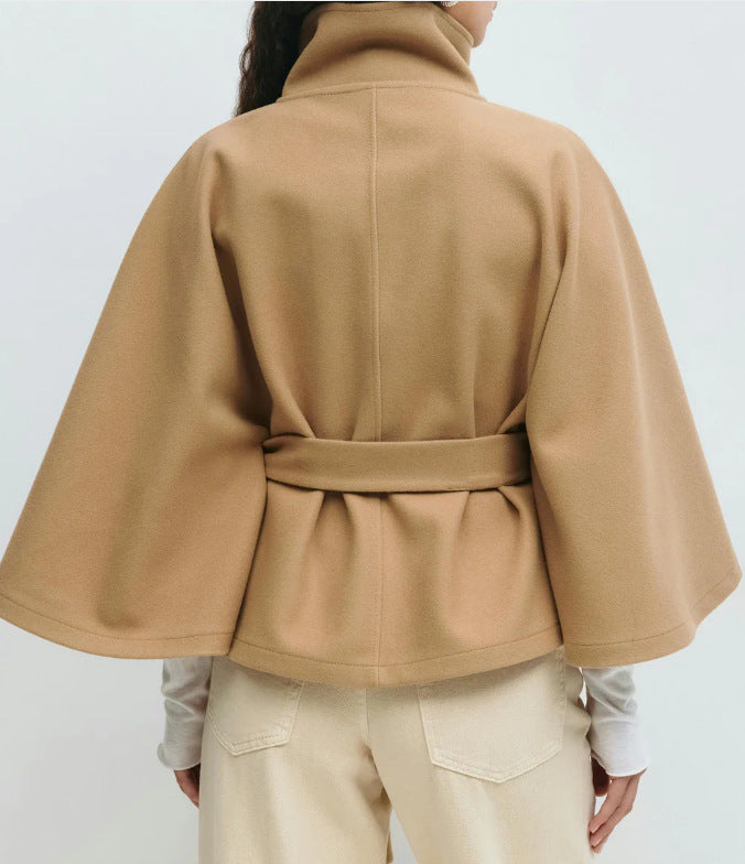 Woman in belted short cape coat
