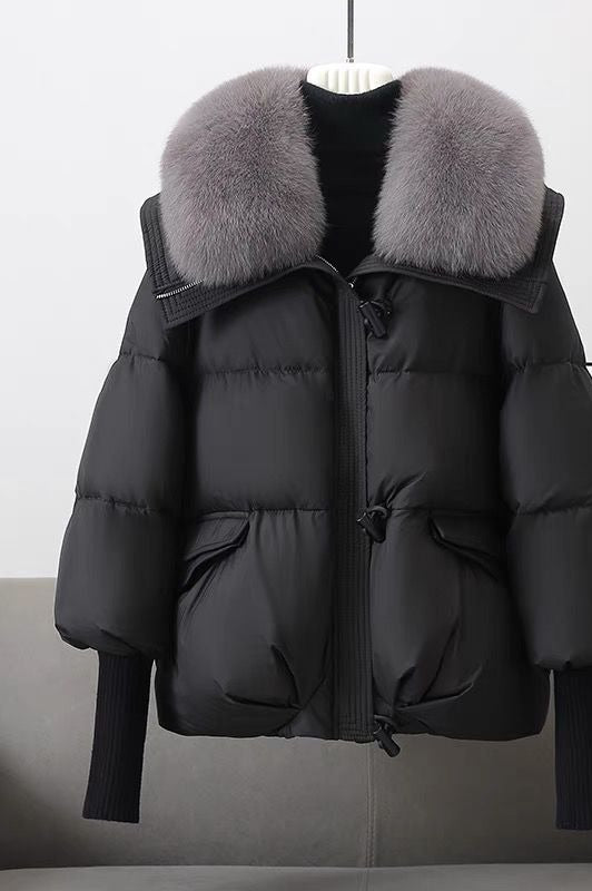 Woman in short puffer jacket with fur collar
