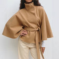 Woman in belted short cape coat